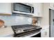 Modern kitchen with stainless steel appliances and white cabinets at 3311 Cranston Ln, Kennesaw, GA 30144