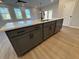 Modern kitchen island with gray cabinets, quartz countertops, and black hardware at 3311 Cranston Ln, Kennesaw, GA 30144