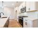 Modern kitchen with white cabinets, quartz countertops, and stainless steel appliances at 3311 Cranston Ln, Kennesaw, GA 30144