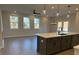 Open kitchen with island, white quartz countertops, and gray cabinets at 3311 Cranston Ln, Kennesaw, GA 30144