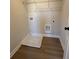 A compact laundry area features hookups and a utility sink inside of a closet at 3311 Cranston Ln, Kennesaw, GA 30144