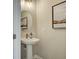 Elegant powder room with pedestal sink and gold fixtures at 3311 Cranston Ln, Kennesaw, GA 30144