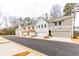 Street view of new townhomes with attached garages, diverse facade colors, and modern architectural details at 3311 Cranston Ln, Kennesaw, GA 30144