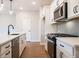 Modern kitchen with white cabinets, stainless steel appliances, and gray backsplash at 3305 Cranston Ln, Kennesaw, GA 30144