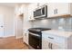 Modern kitchen with white cabinets, stainless steel appliances, and gray backsplash at 3305 Cranston Ln, Kennesaw, GA 30144