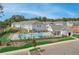 View of community pool, clubhouse, and surrounding townhomes at 3305 Cranston Ln, Kennesaw, GA 30144