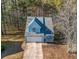 Aerial view of a light blue house with a gray roof and attached garage at 5392 Brickleberry Way, Douglasville, GA 30134