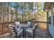 Wooden deck with table and chairs, overlooking wooded area at 5392 Brickleberry Way, Douglasville, GA 30134