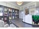 Bright home office with glass-front bookcase and French doors at 155 Sunshower Rdg, Canton, GA 30114