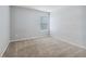 Bedroom with wood-look accent wall and neutral-toned carpet at 253 N Gwinnett St, Buford, GA 30518