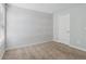 Bedroom featuring a wood-plank accent wall and carpet flooring at 253 N Gwinnett St, Buford, GA 30518