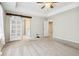 Main bedroom with carpet, barn door, and bathroom access at 253 N Gwinnett St, Buford, GA 30518