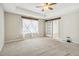 Main bedroom with window, ceiling fan, and barn door at 253 N Gwinnett St, Buford, GA 30518