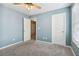 Blue bedroom with two doors and window at 253 N Gwinnett St, Buford, GA 30518