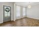 Bright dining area with hardwood floors and gray door at 253 N Gwinnett St, Buford, GA 30518