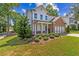 Two-story brick and white home with landscaped yard and attached garage at 253 N Gwinnett St, Buford, GA 30518