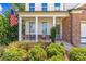 Charming front porch with white columns and American flag at 253 N Gwinnett St, Buford, GA 30518