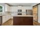 Modern kitchen with granite countertops, stainless steel appliances, and island at 253 N Gwinnett St, Buford, GA 30518