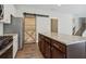 Kitchen features granite countertops, stainless steel appliances, and barn door at 253 N Gwinnett St, Buford, GA 30518