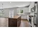 Kitchen island with granite countertops and stainless steel appliances at 253 N Gwinnett St, Buford, GA 30518