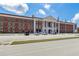 Exterior view of a large brick school building with parking at 253 N Gwinnett St, Buford, GA 30518