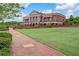 Brick pathway, lush green lawn, and community center at 253 N Gwinnett St, Buford, GA 30518