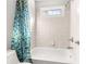 Clean bathroom with a shower/tub combo and a patterned shower curtain at 5507 Ashleigh Walk Nw Dr, Suwanee, GA 30024