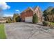 Side view of a house showing the driveway and garage at 5507 Ashleigh Walk Nw Dr, Suwanee, GA 30024