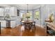 Kitchen breakfast nook with hardwood floors and a view of the backyard at 5507 Ashleigh Walk Nw Dr, Suwanee, GA 30024