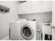 Bright laundry room complete with washer, dryer, and utility sink at 5507 Ashleigh Walk Nw Dr, Suwanee, GA 30024