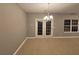 Bright dining room with tile floors and chandelier at 4461 Ravenwood Dr, Union City, GA 30291