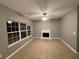 Living room with fireplace and ceiling fan at 4461 Ravenwood Dr, Union City, GA 30291