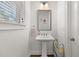 Clean and bright bathroom with pedestal sink and silver mirror at 1072 Heyward Way, Alpharetta, GA 30009