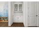 White built-in pantry with glass-front cabinets and white countertop at 1072 Heyward Way, Alpharetta, GA 30009