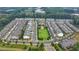 Aerial view of community with homes and open green space at 1072 Heyward Way, Alpharetta, GA 30009