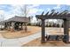 Covered pavilion with picnic tables and swing next to grassy area at 1072 Heyward Way, Alpharetta, GA 30009