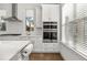 Modern kitchen with white cabinets and stainless steel appliances at 1072 Heyward Way, Alpharetta, GA 30009