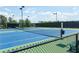 Tennis court with fence and lights at 1072 Heyward Way, Alpharetta, GA 30009