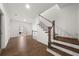 Bright hallway with hardwood floors and staircase leading upstairs at 1072 Heyward Way, Alpharetta, GA 30009