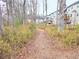 View of walking trail surrounded by trees with houses in the background at 2695 Mourning Dove Drive (Lot 54), Grayson, GA 30017