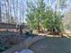 Wooded backyard with retaining wall and steps at 1550 Oak Creek Dr, Marietta, GA 30066