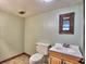 Basement bathroom with a toilet, sink, and mirror at 1550 Oak Creek Dr, Marietta, GA 30066