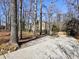 House exterior showcasing a large driveway and mature trees surrounding the property at 1550 Oak Creek Dr, Marietta, GA 30066