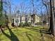 Tan house with wood-like siding, surrounded by trees and landscaping at 1550 Oak Creek Dr, Marietta, GA 30066