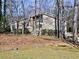 Tan house with wood-like siding, surrounded by trees and landscaping at 1550 Oak Creek Dr, Marietta, GA 30066