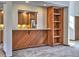 Kitchen breakfast bar with wood paneling and view into the kitchen at 1550 Oak Creek Dr, Marietta, GA 30066