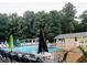 Community pool with lounge chairs and umbrellas at 1550 Oak Creek Dr, Marietta, GA 30066