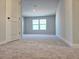 Neutral bedroom with carpet, large window, and walk-in closet at 2422 Brown Dove Way Lot 70, Grayson, GA 30017