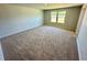 Large bedroom featuring carpet, a window, and neutral walls at 2422 Brown Dove Way Lot 70, Grayson, GA 30017