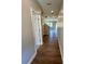 Hallway with wood-look flooring that leads to the upper level, doors, and living spaces at 2422 Brown Dove Way Lot 70, Grayson, GA 30017